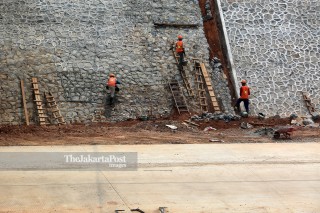 Workers finish the construction of The Jakarta Outer Ring Road II